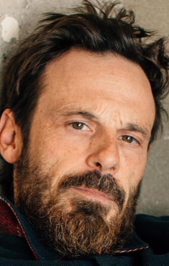 Scoot McNairy -- Father Charles Watkins